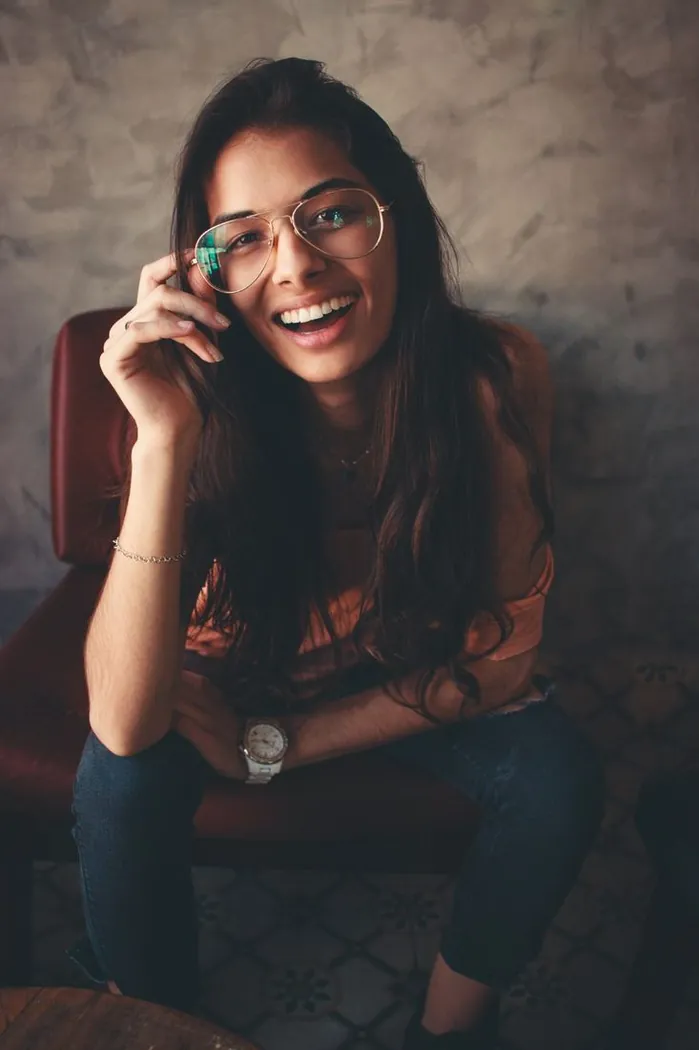 Happy customer wearing stylish gold aviator glasses